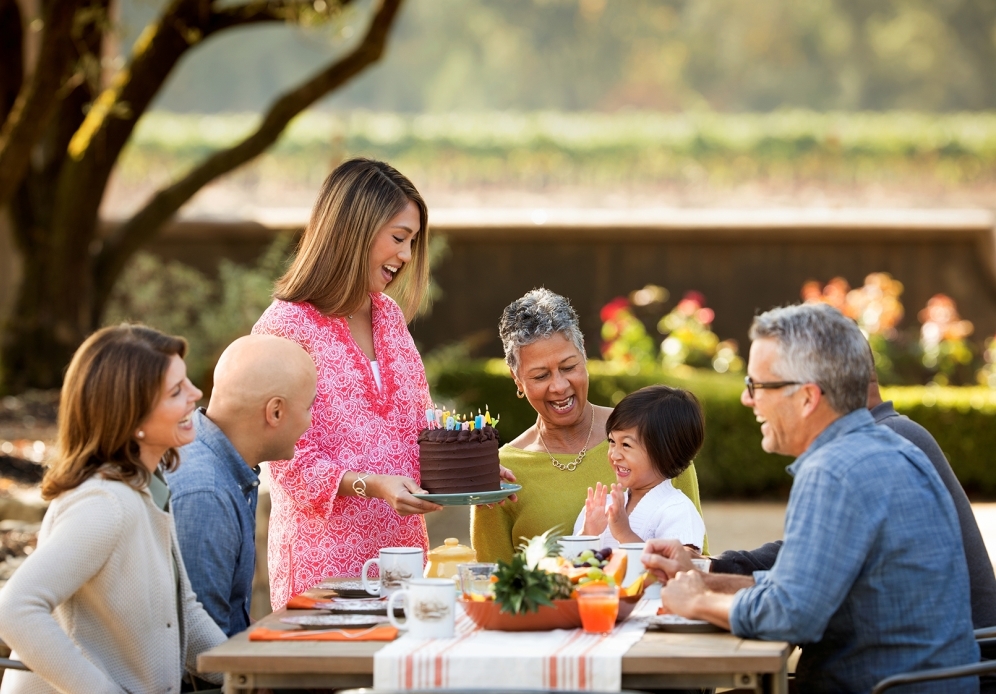Family celebrating birthday outdoors