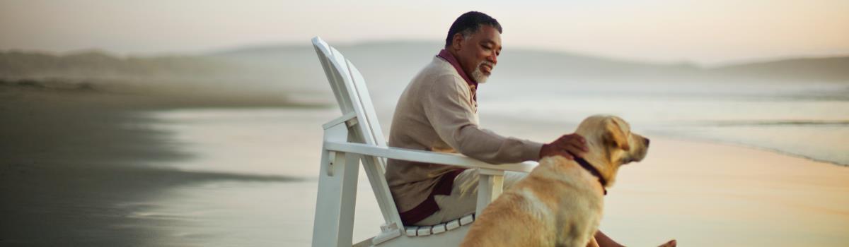 man and dog on beach