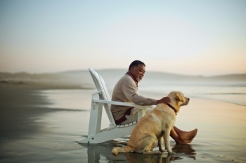 senior man with dog at the beach