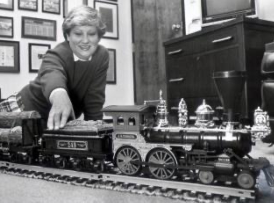 old photo of woman with model train