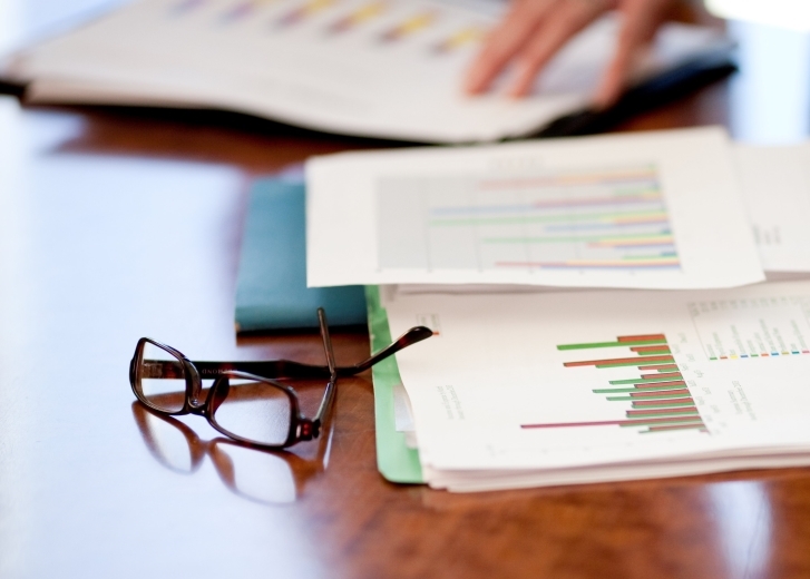 desk with papers and eyeglasses
