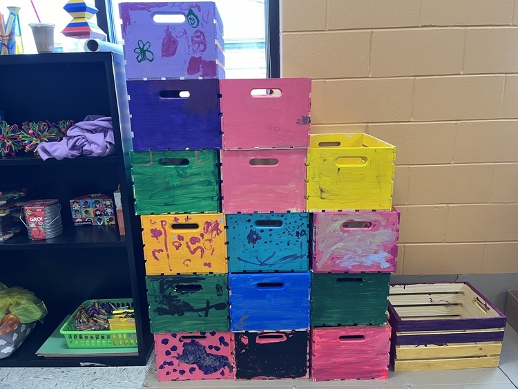 A collection of painted wooden boxes decorated with the designs of Kindergarteners