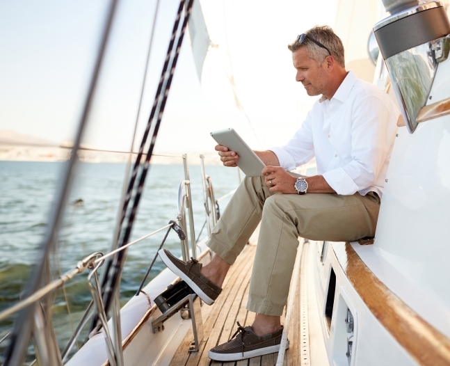 man on a sailboat looking at tabler