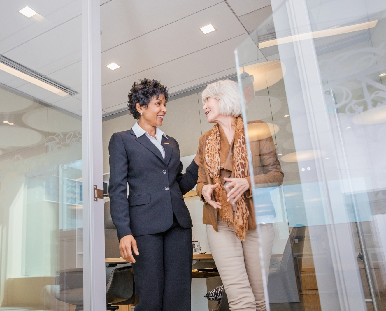 two business women walking out of an office