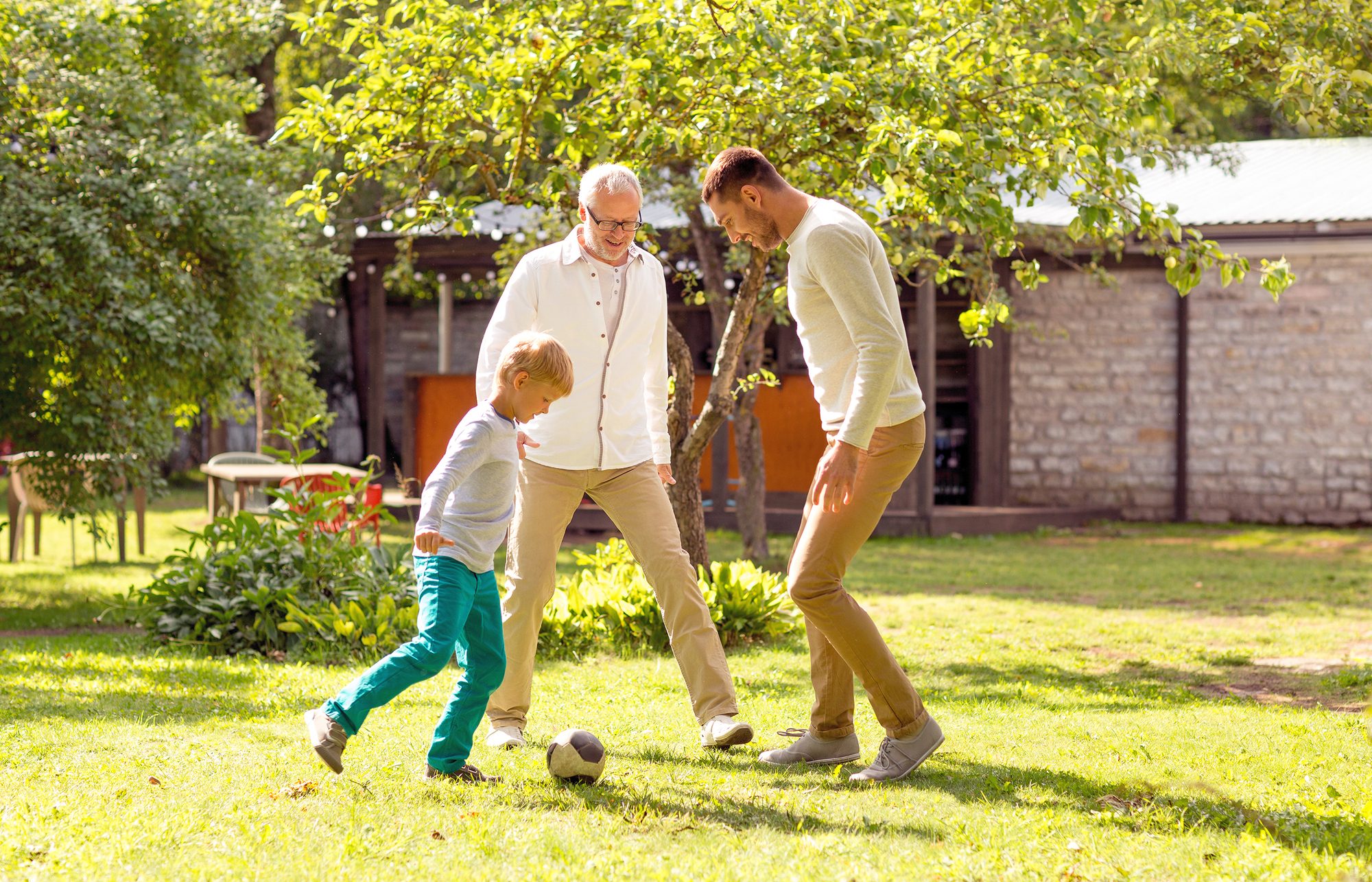 3 generation of men playing outdoors