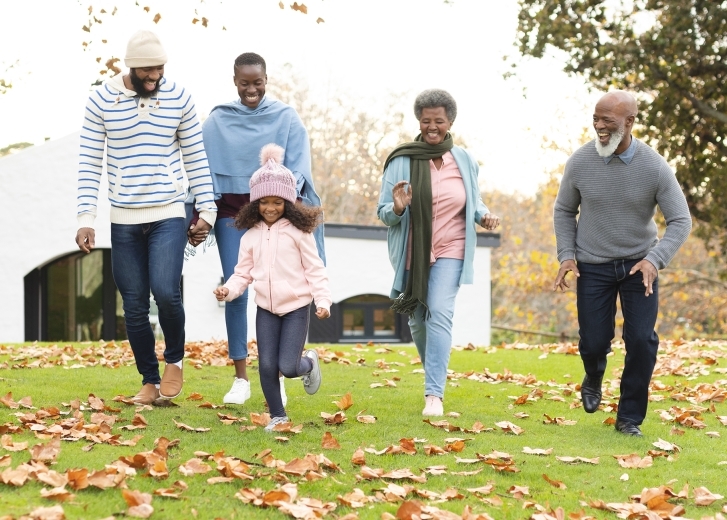 family walking in the fall leaves