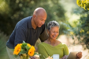 Couple reviewing information on tablet
