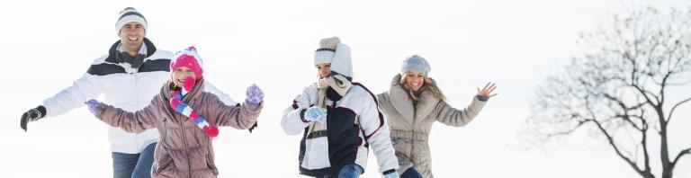 family playing in the snow