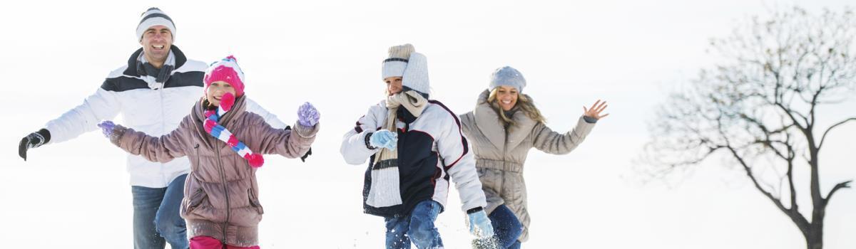 family playing in the snow