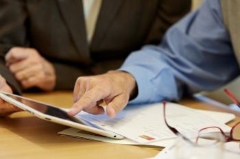 Financial Advisor showing client information on a tablet