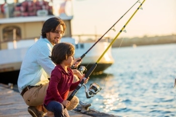 man and son fishing on dock