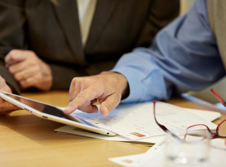 Financial Advisor showing client information on a tablet