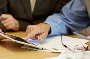 Financial Advisor showing client information on a tablet