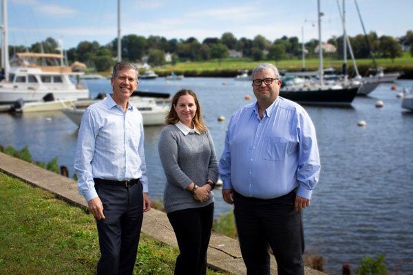 Shearwater Creek Wealth Advisors standing in front of boats in harbor