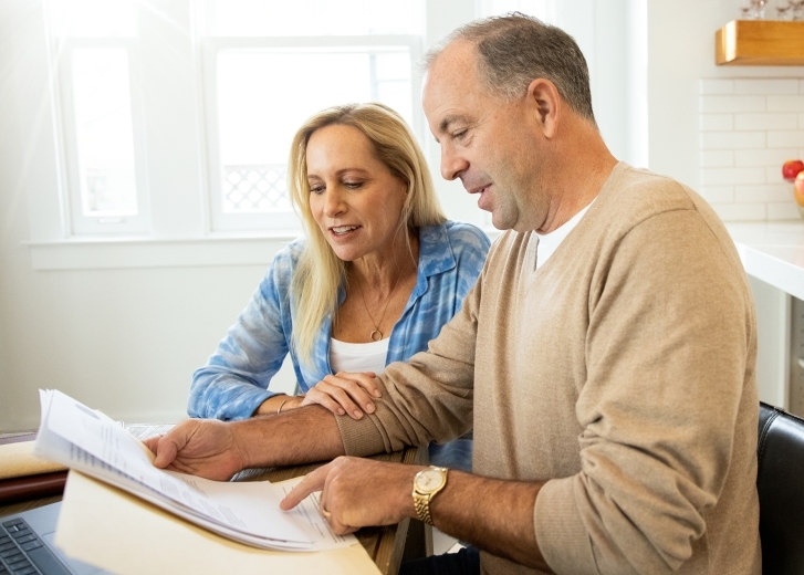 couple at the table looking over paperwork