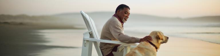 man and dog on beach