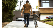 Man and his son walking and holding hands