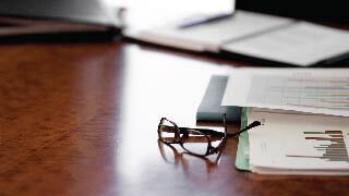 glasses and papers on a desk