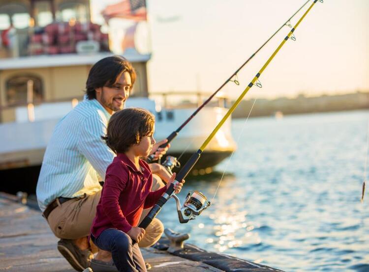 man and son fishing on dock