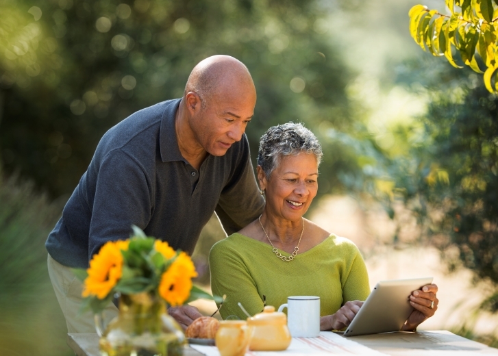 man and woman looking at tablet