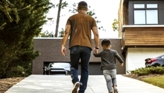 Man and his son walking and holding hands