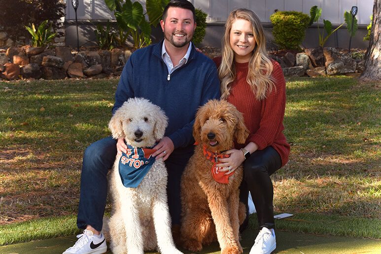 Taylor and her husband Parker with their two goldendoodles, Banks and Bear 