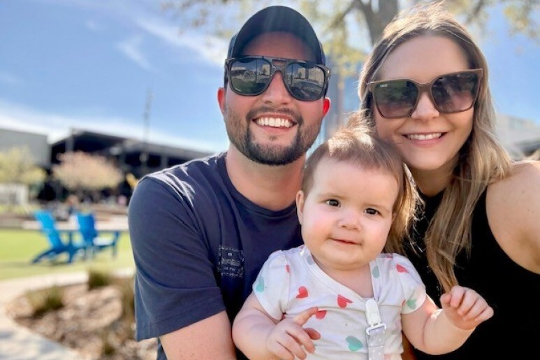 Taylor and Daughter Palmer, with Husband Parker, outside