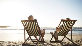 couple in beach chairs on beach