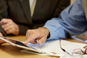 Financial Advisor showing client information on a tablet