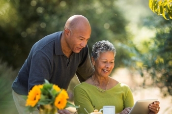 Couple reviewing information on tablet