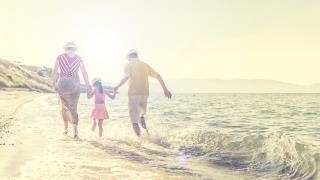 family walking by the ocean