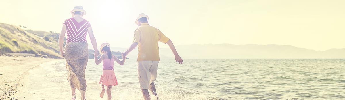 family walking by the ocean