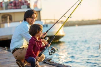 man and son fishing on dock